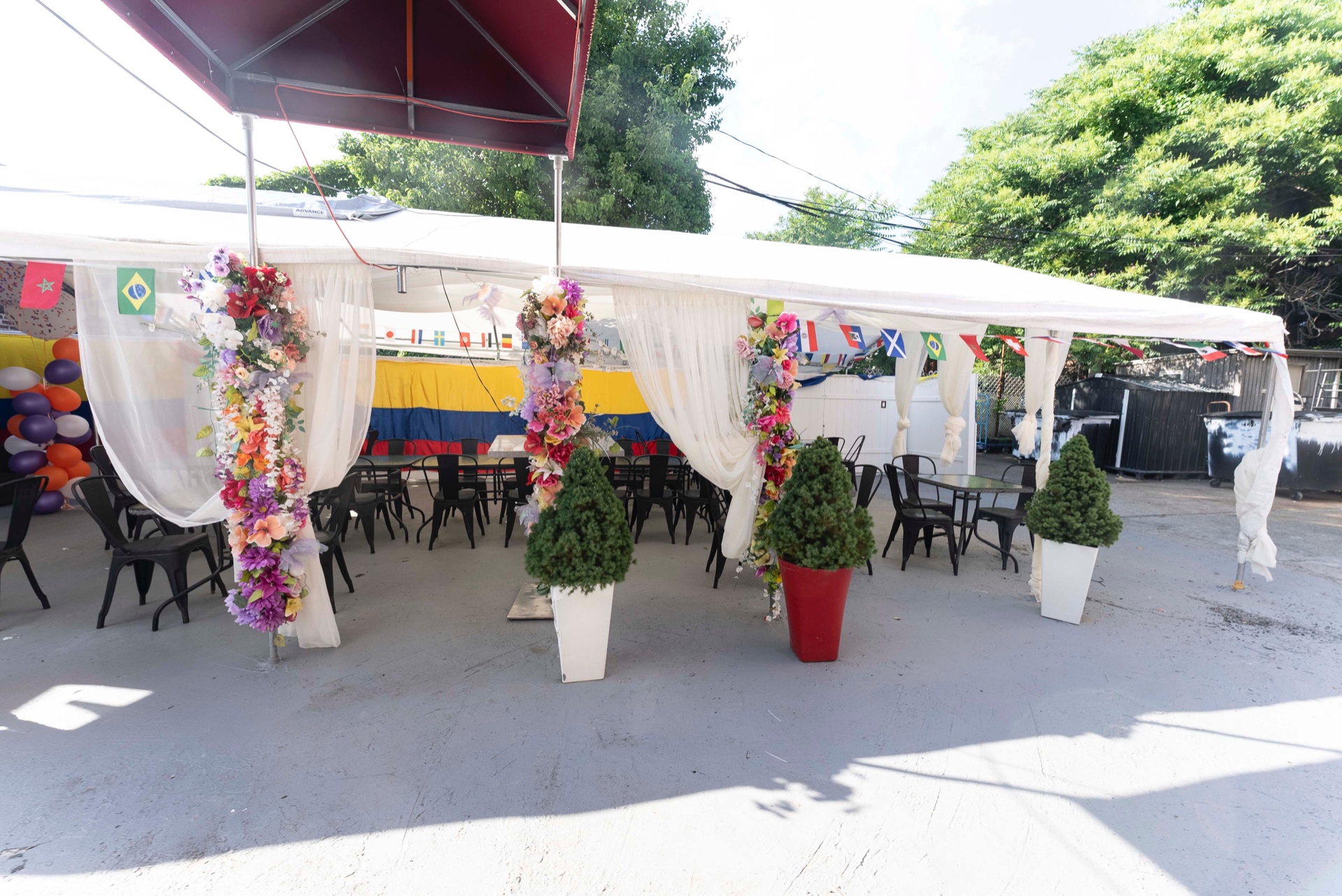 Patio tent decorated with flowers and flags