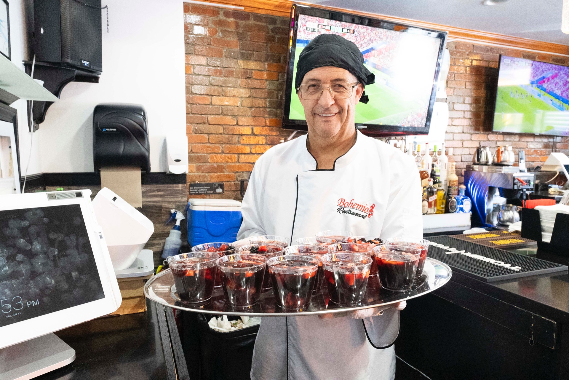 Chef and owner of Bohemios with a tray of sangria